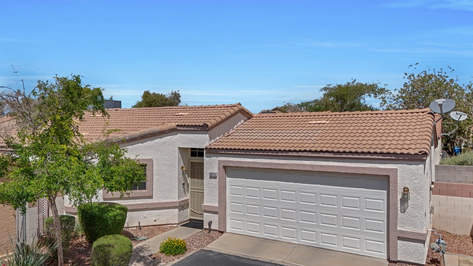 Single-story front exterior with tile roof at the Timorasso plan home in Inspirada, Henderson NV