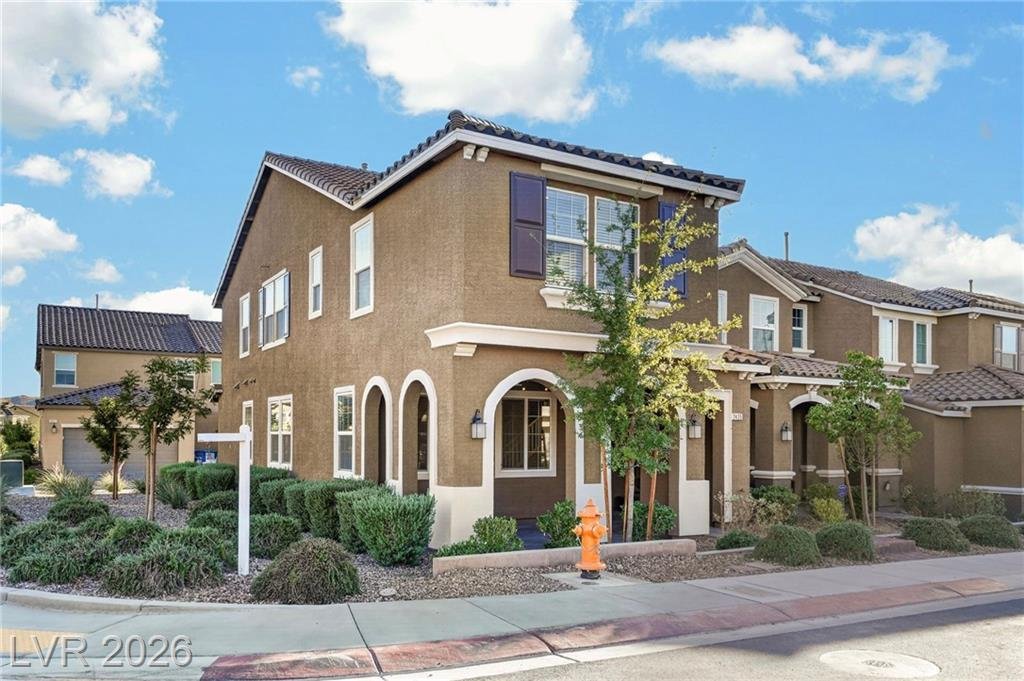 Front exterior of 2435 Bellinzona Place, a two-story townhome on a premium corner lot in Inspirada, Henderson NV