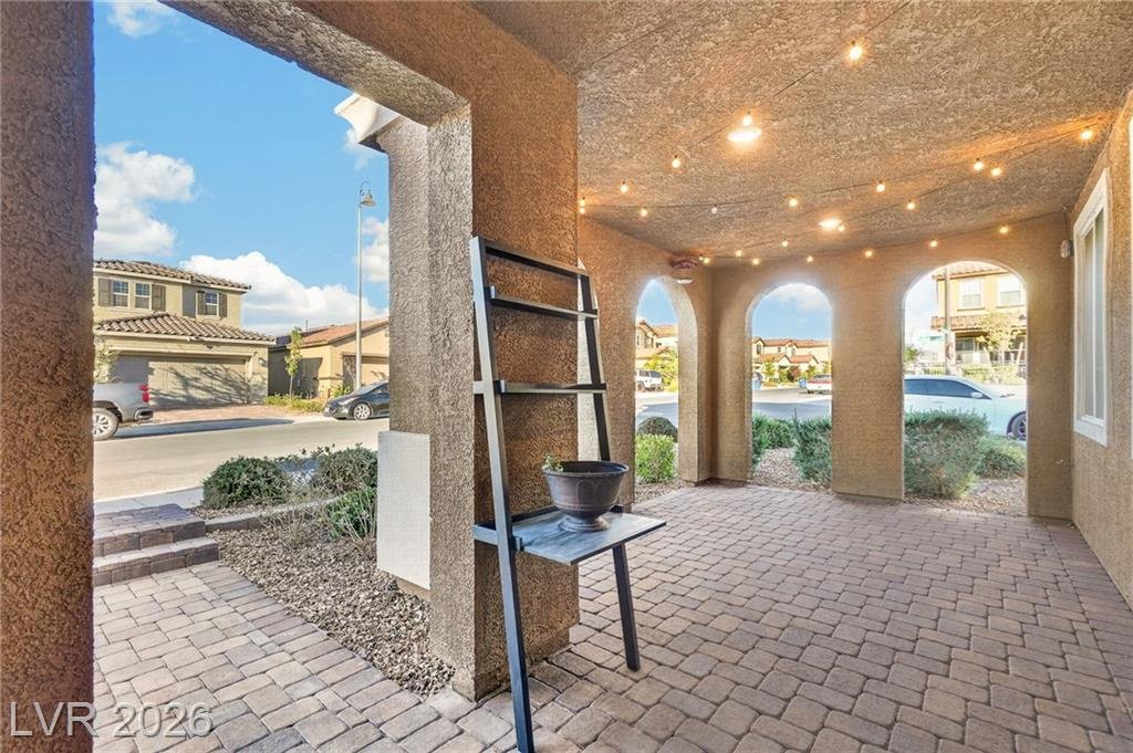 Covered front courtyard with string lights at 2435 Bellinzona Place