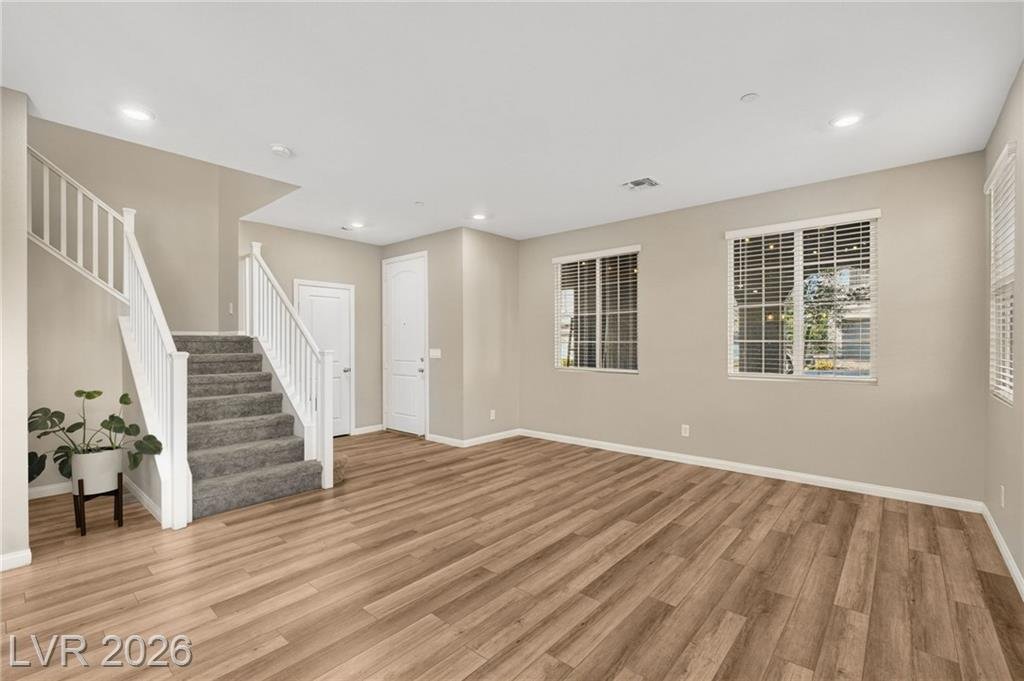 Great room and staircase with luxury vinyl plank flooring