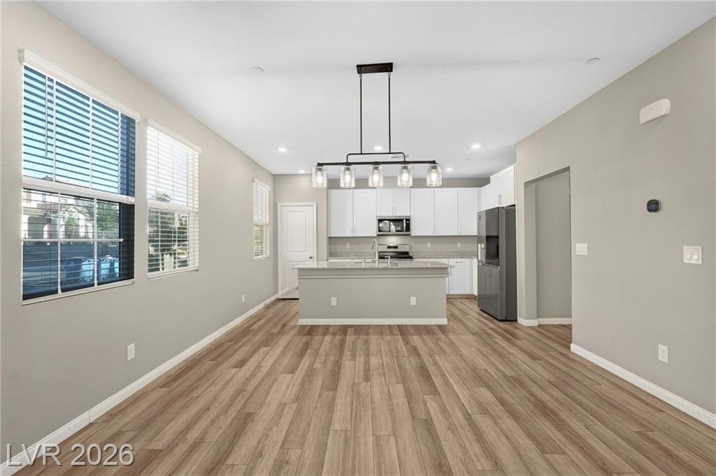 Kitchen with large island, breakfast bar and black linear pendant light