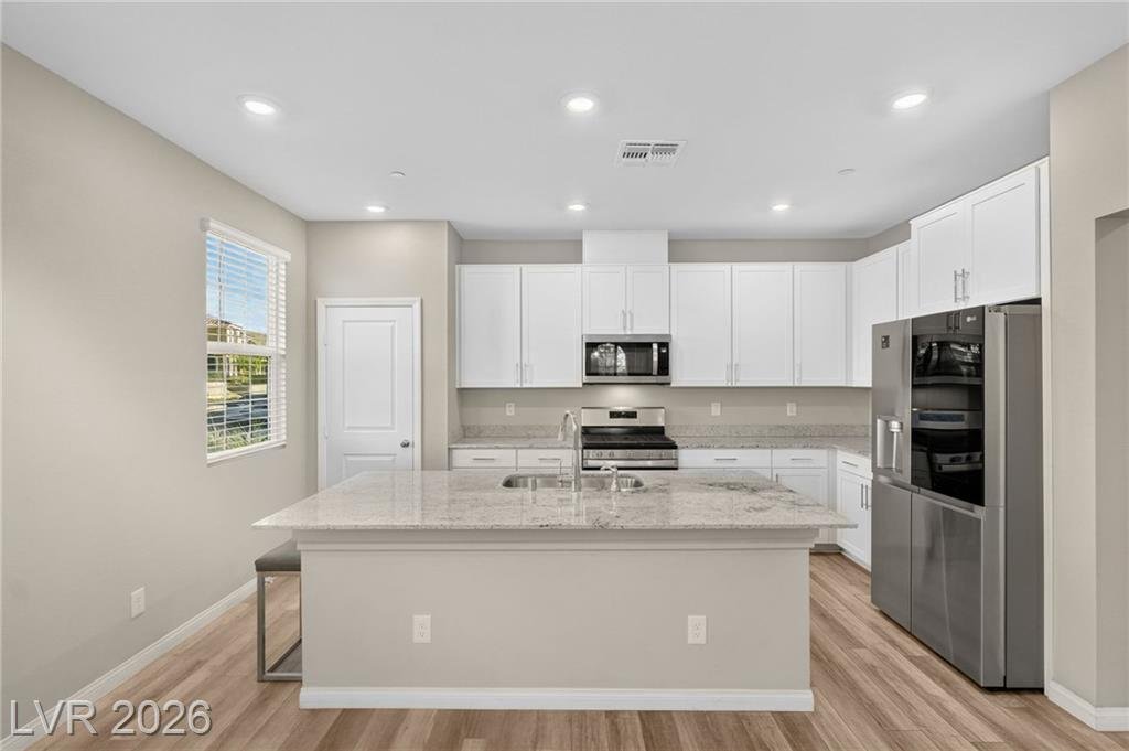 Kitchen with stainless steel range, microwave and refrigerator included