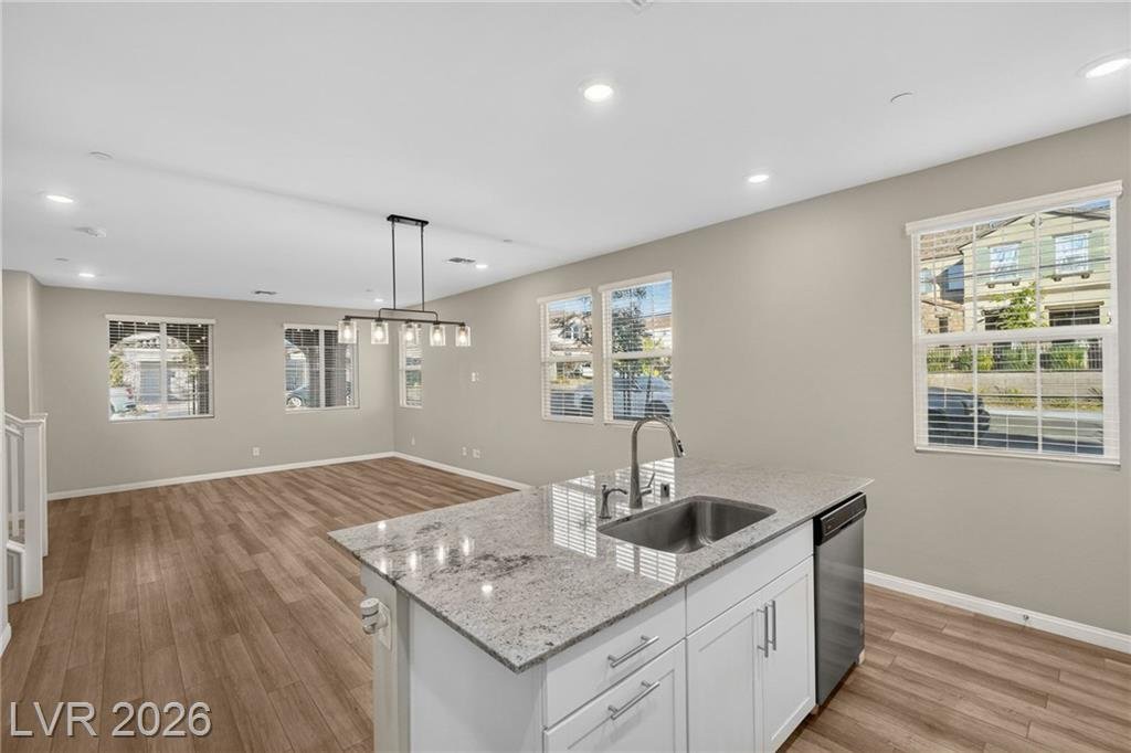 Kitchen island sink and dishwasher open to the dining area