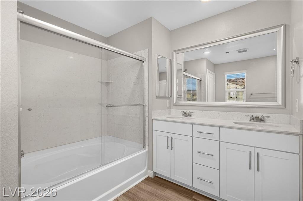 Primary bathroom with double vanity and tub-shower