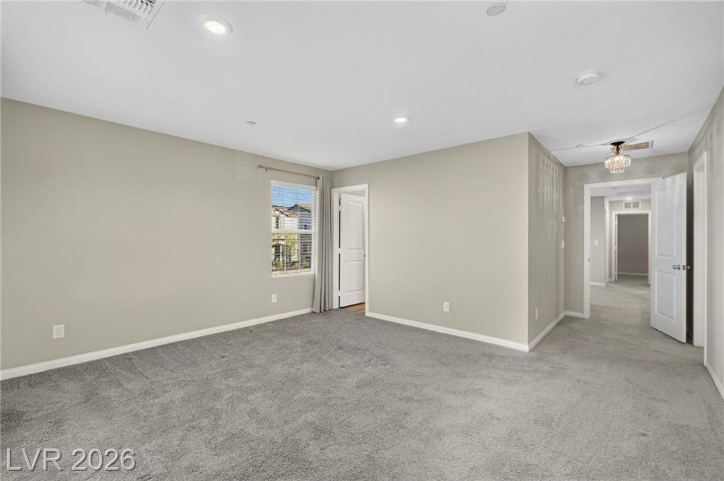 Secondary bedroom with ceiling fan and closet
