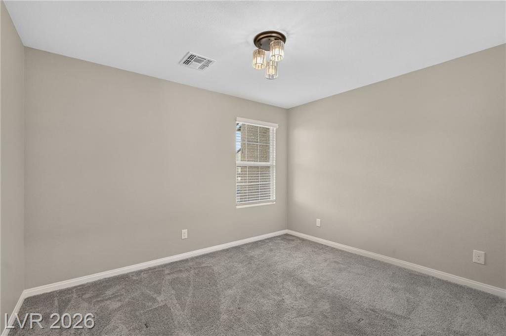 Third bedroom with brass ceiling light