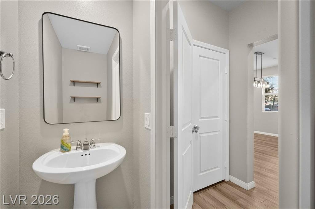 Downstairs half bathroom with pedestal sink