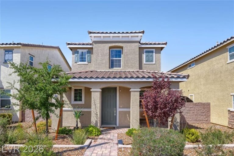 Front elevation of 2495 Adige Place with tile roof and desert landscaping