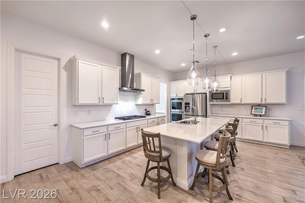Kitchen with gas cooktop, upgraded hood and built-in double ovens
