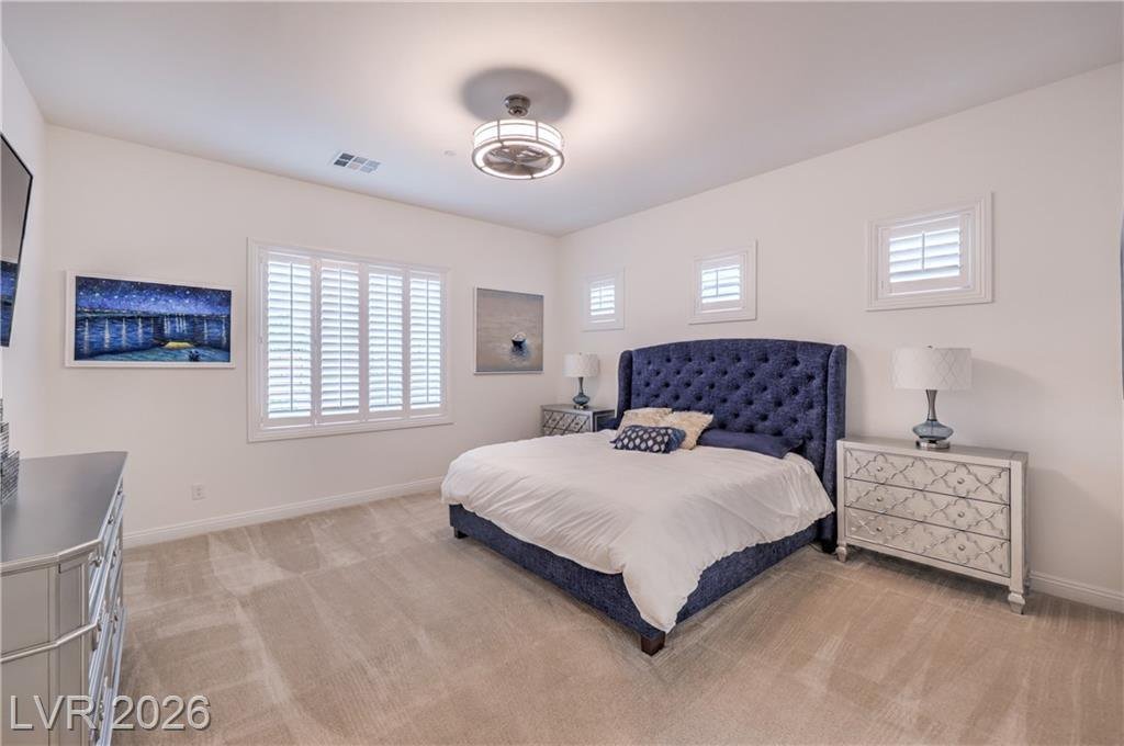 Owner's suite with ceiling fan and 10 foot ceilings