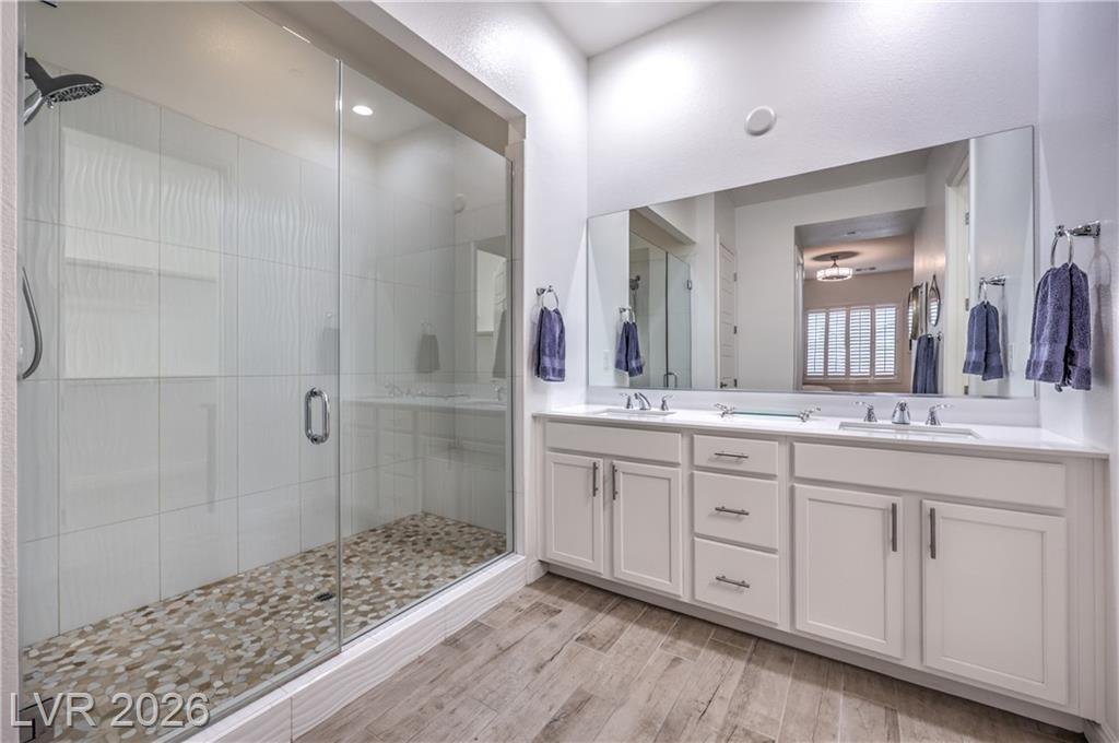 Owner's bath with dual sinks, raised vanity and oversized walk-in shower