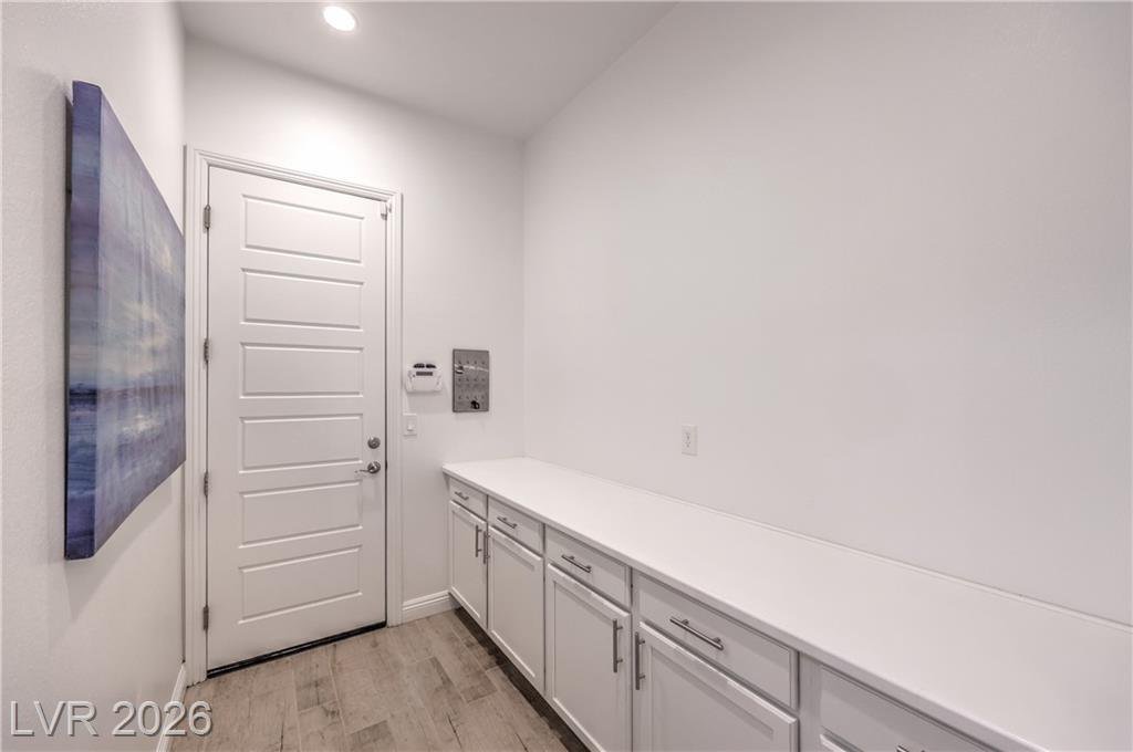 Laundry room with cabinets and utility sink