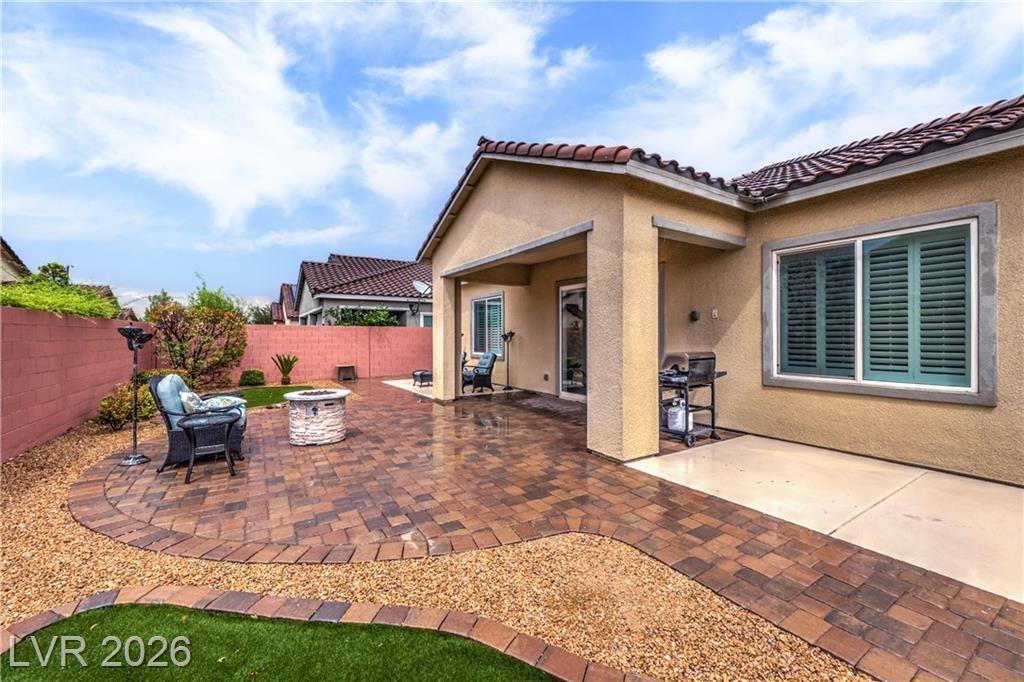 Private backyard with paver patio and fire pit