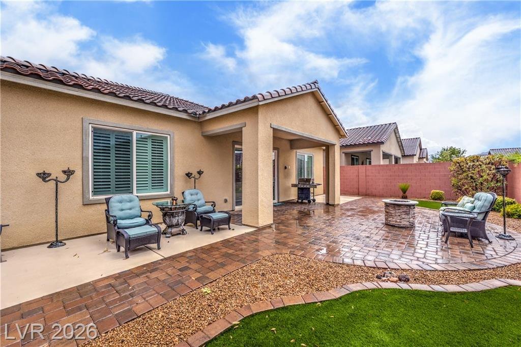 Covered patio and paver seating area in the backyard