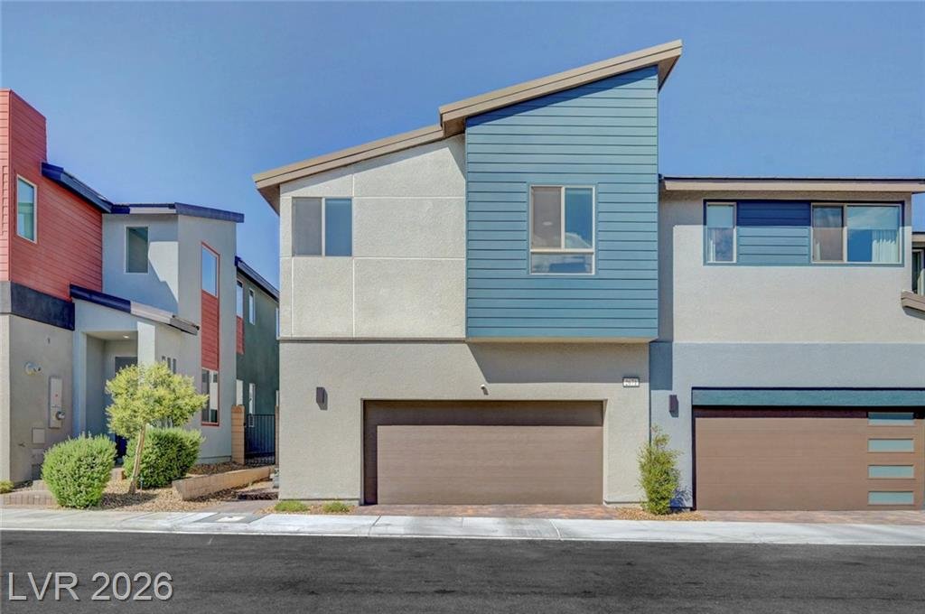 Front exterior of 2671 Kindswood Street, a modern 2024 Tri Pointe townhome on a premium corner lot in Inspirada, Henderson NV