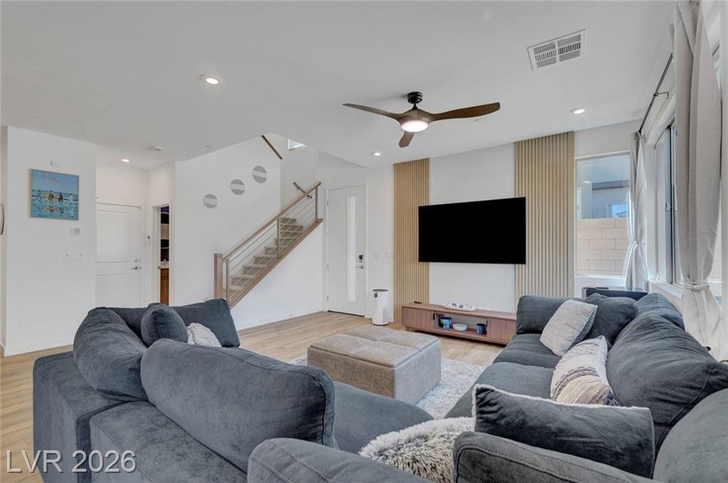 Living area with abundant corner-unit windows and natural light