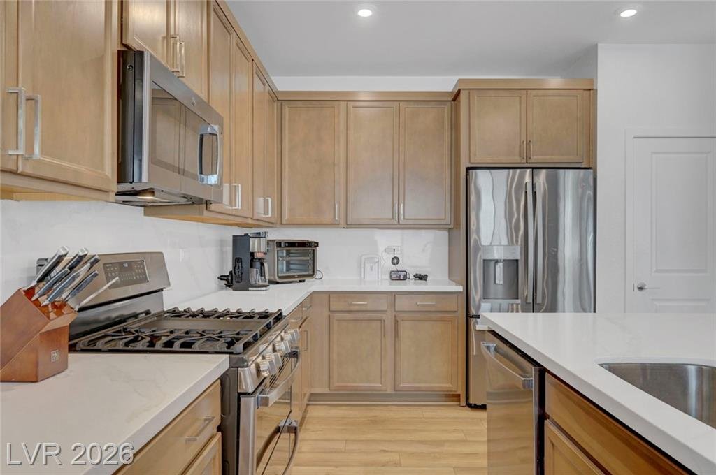 Kitchen with stainless steel range and pantry