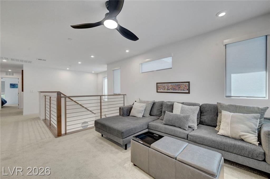 Upstairs loft off the primary suite with ceiling fan