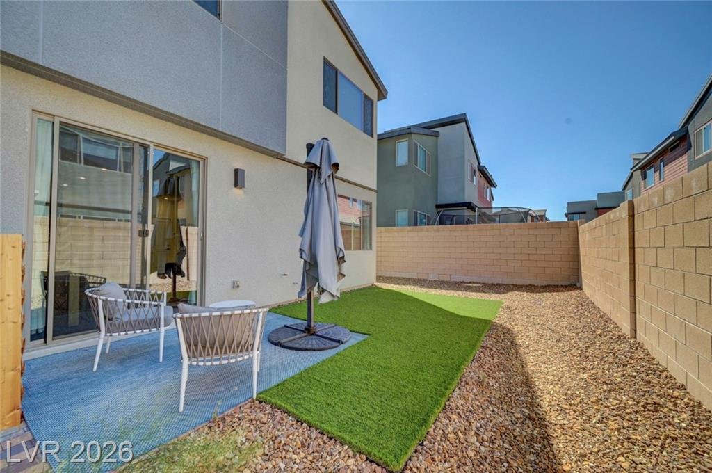 Backyard with low-maintenance turf and paver patio