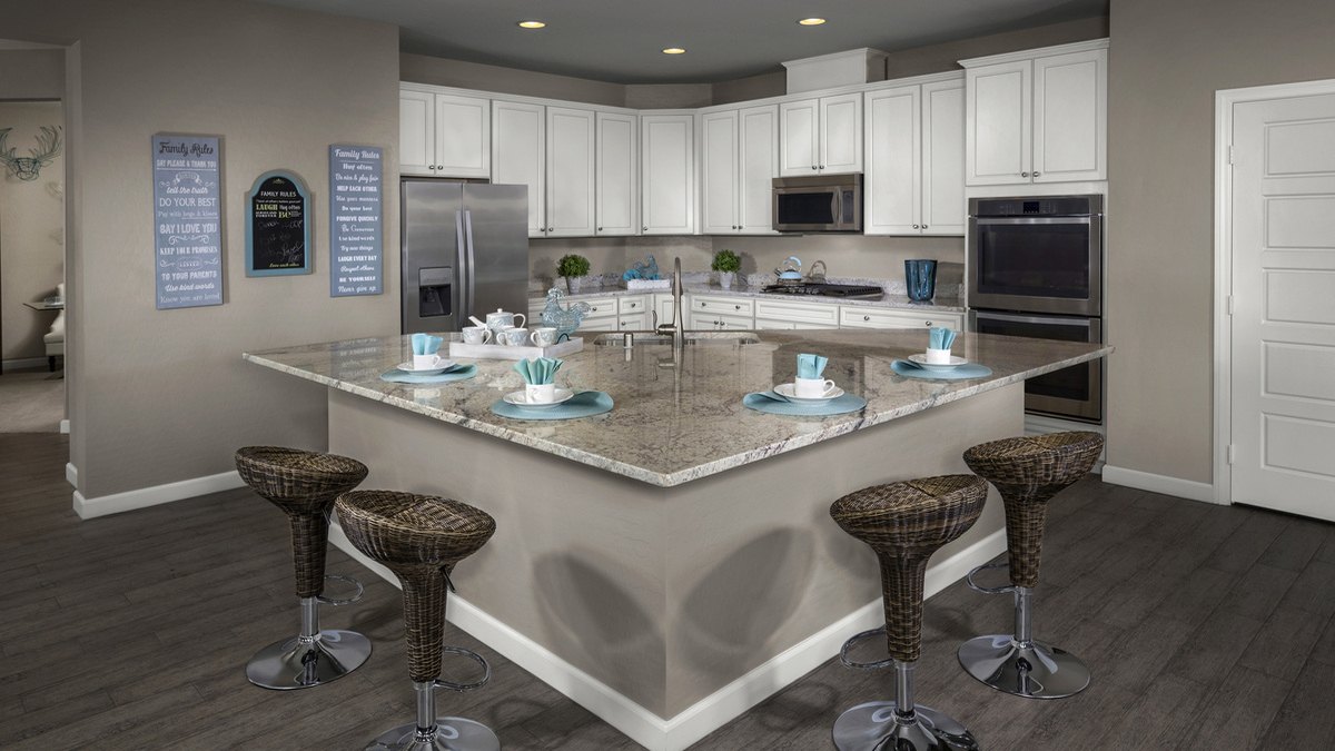 Kitchen and granite island in the KB Home Plan 2170 model at Enclaves in Inspirada, Henderson NV