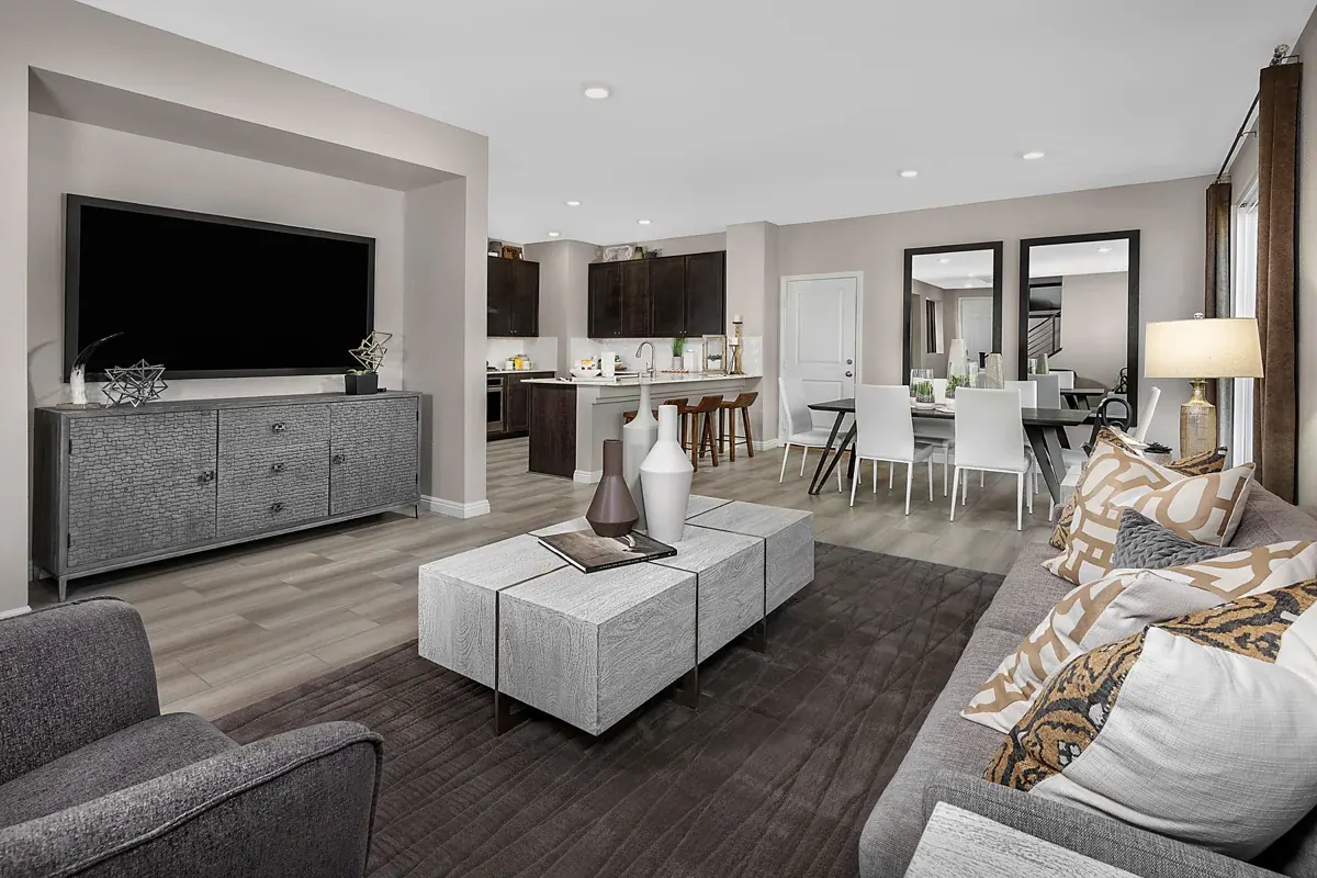 Open-concept great room, kitchen and dining area in the KB Home Plan 2044 model at Gardens in Inspirada, Henderson NV