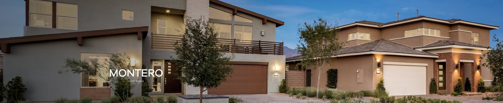 Two Montero model homes at dusk in Inspirada, Henderson NV, built by Pardee Homes - a gray modern two-story with a second-floor deck and a tan tile-roof plan with a lit courtyard entry