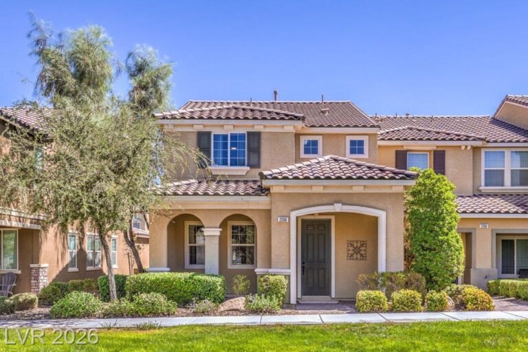 Front of 2266 Lambro Street, an end-unit townhome with a tile roof and arched courtyard entry