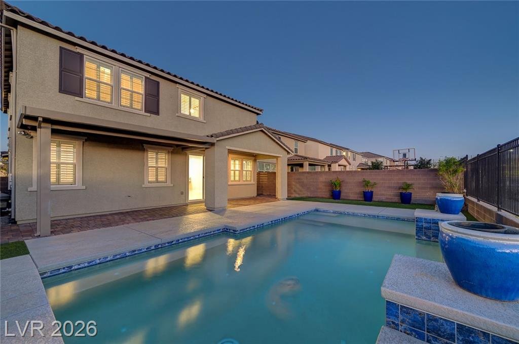 Pool at 2587 Tolmezzo Street looking back at the two-story rear elevation