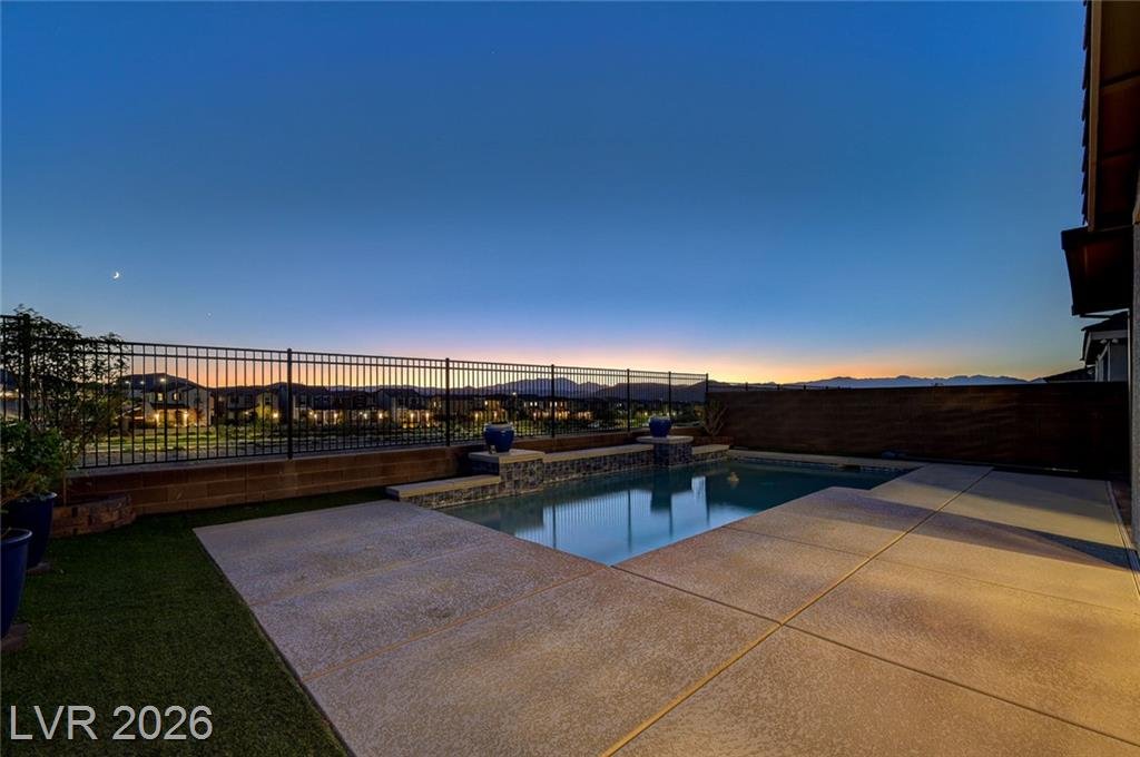Synthetic turf strip beside the pool deck with mountains on the horizon