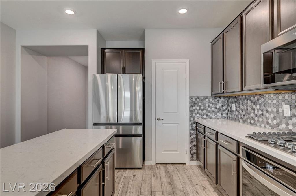 Gas cooktop, built-in wall oven and stainless range hood