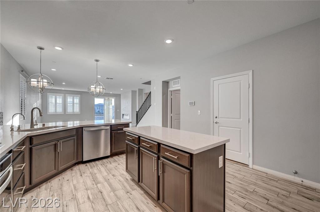 Kitchen sink under shuttered windows at 2587 Tolmezzo Street with a view to the living room