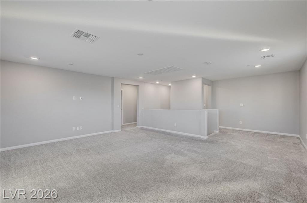 Massive upstairs loft at 2587 Tolmezzo Street with a half wall overlooking the stairs