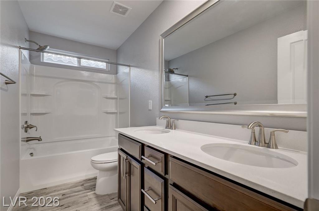 Upstairs hall bath with a tub-shower combination and double sinks
