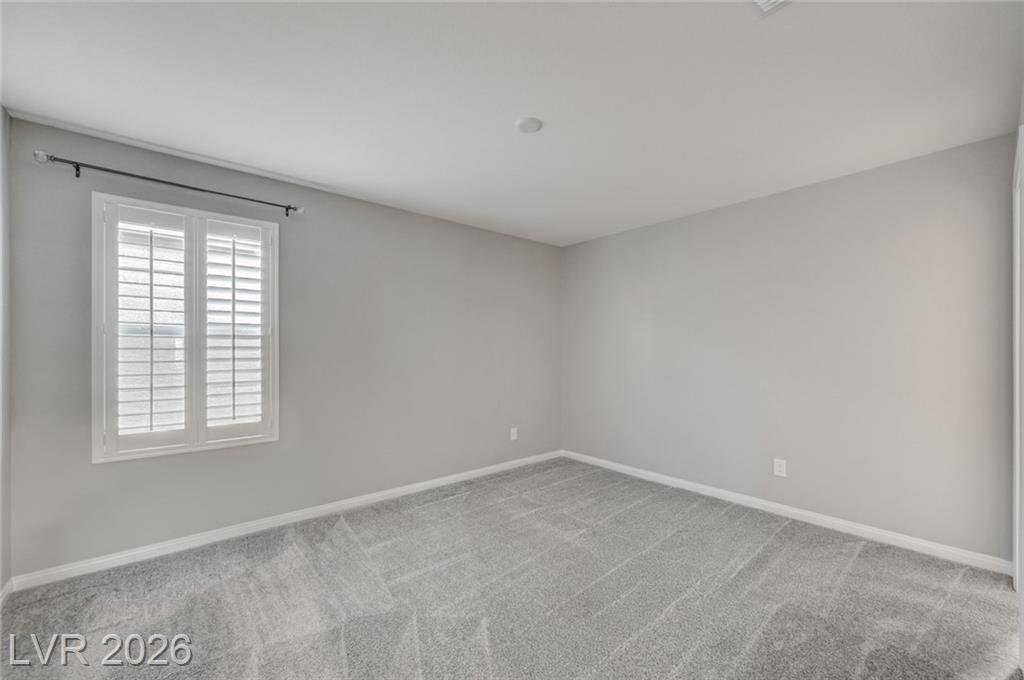 Bedroom three at 2587 Tolmezzo Street with a shuttered window and carpet