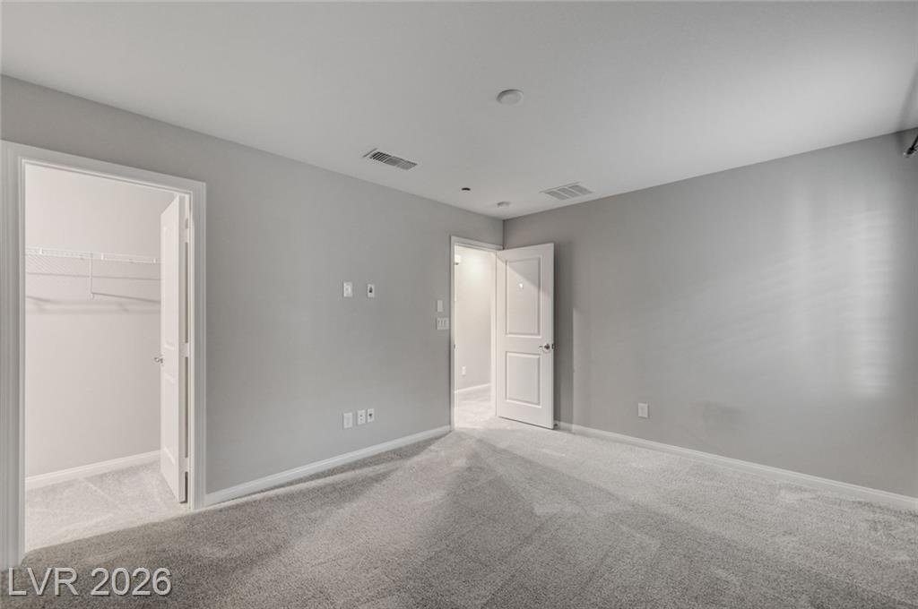 Third bedroom with a door to its own walk-in closet