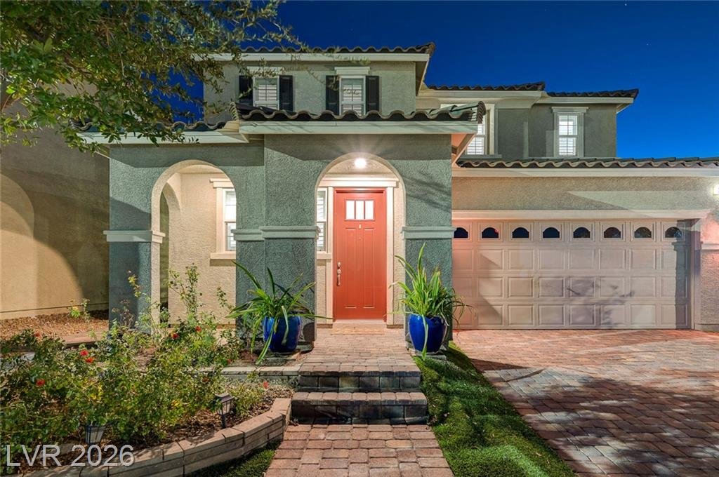 Arched front porch and red door at 2587 Tolmezzo Street