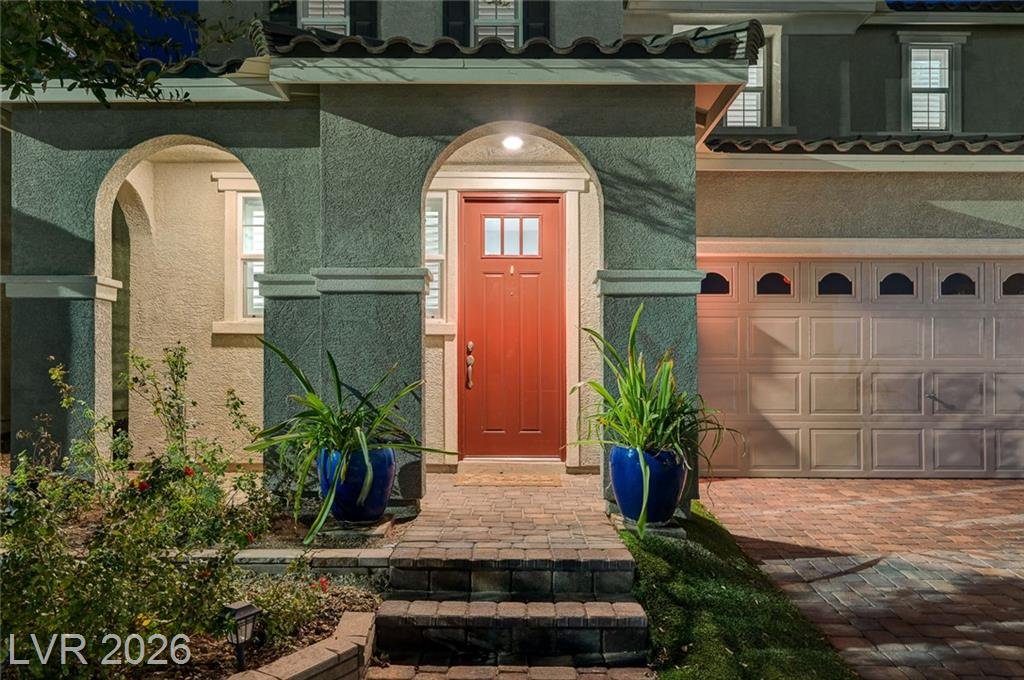 Covered front porch with a coach light and blue ceramic planters