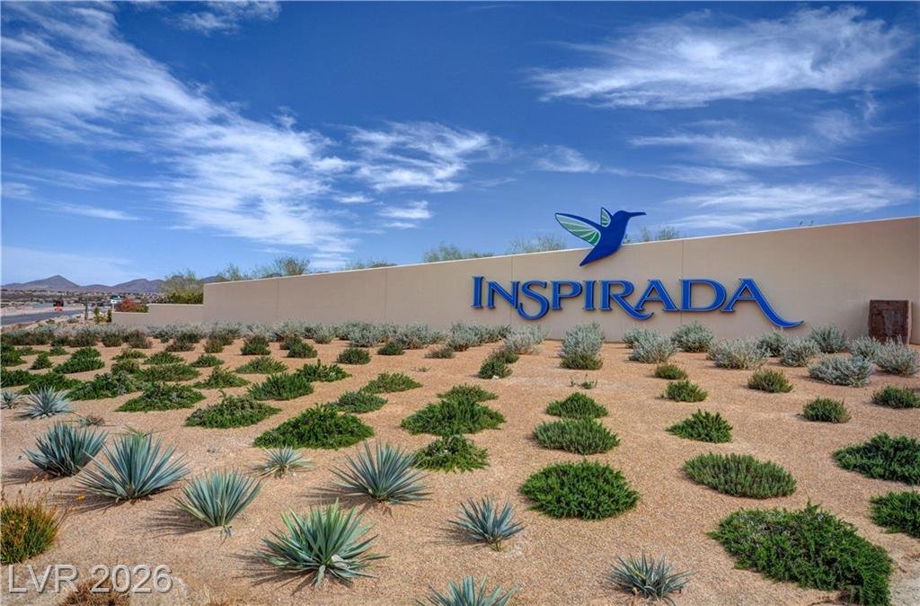 Inspirada entry monument with hummingbird logo and desert landscaping