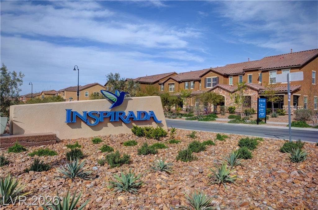 Inspirada monument sign in front of tile-roof townhomes