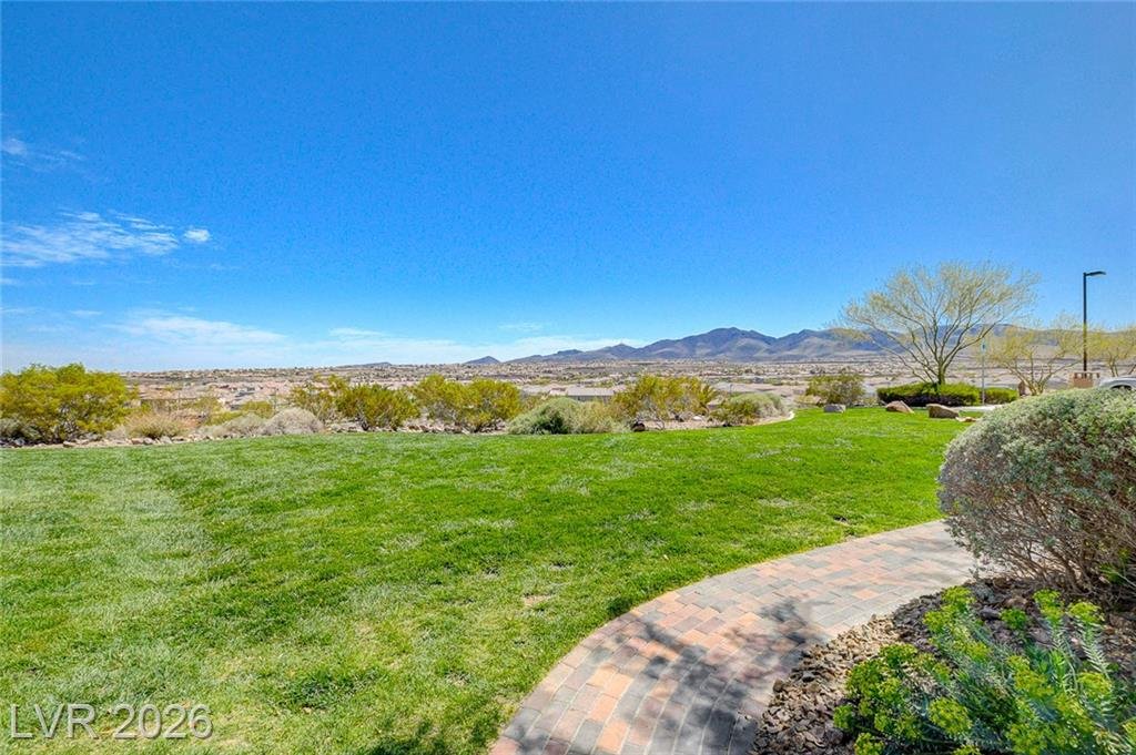 Hilltop lawn with a curving paver path
