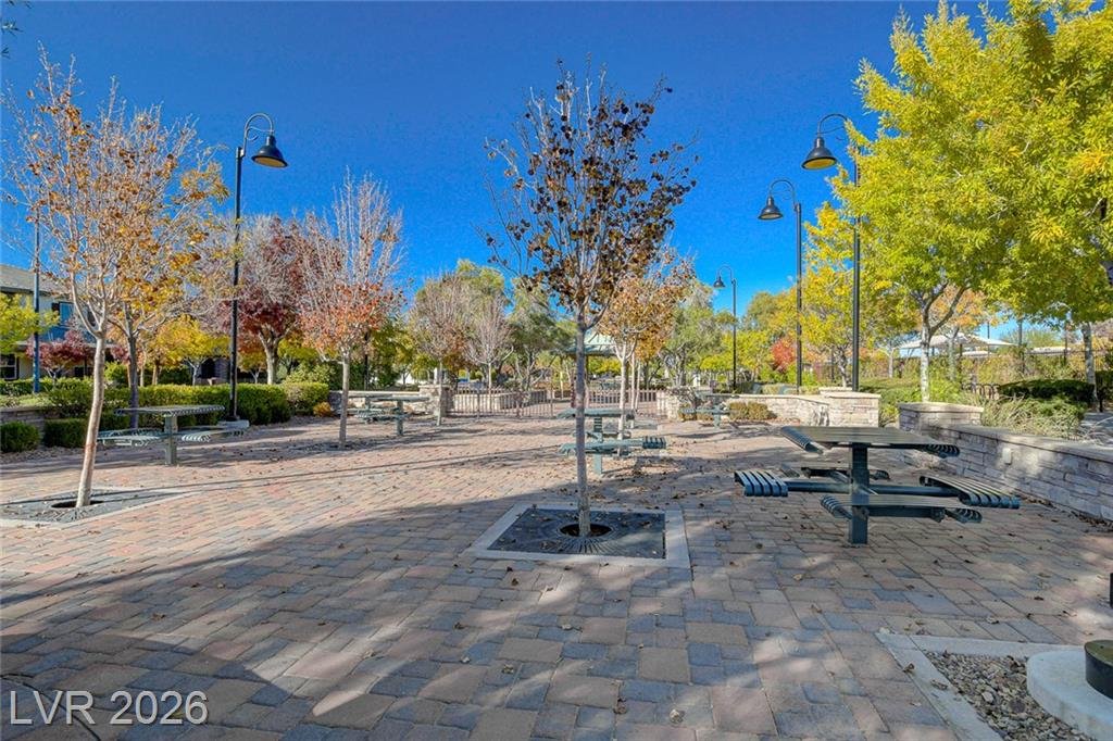 Paver plaza with picnic tables under autumn trees