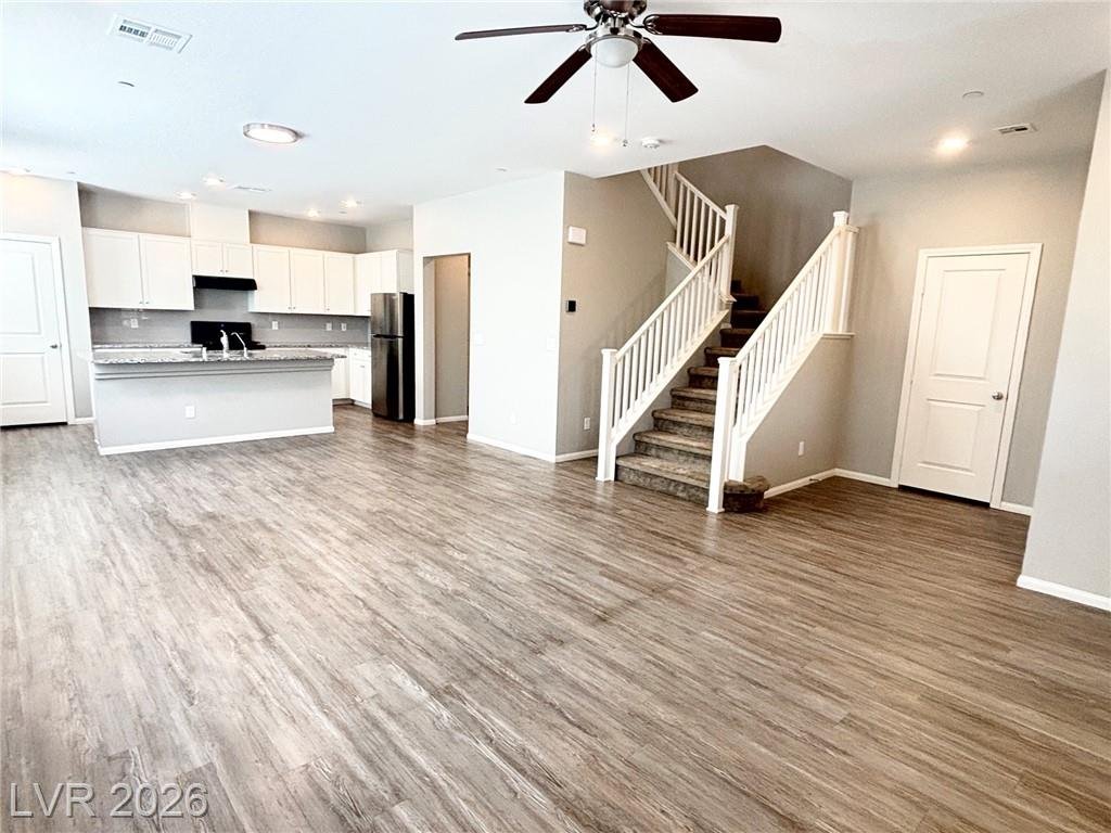 Great room looking toward the kitchen and the staircase