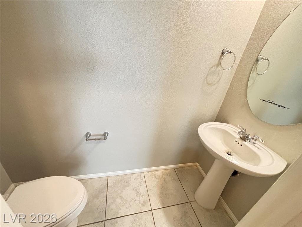 Downstairs half bathroom with a pedestal sink