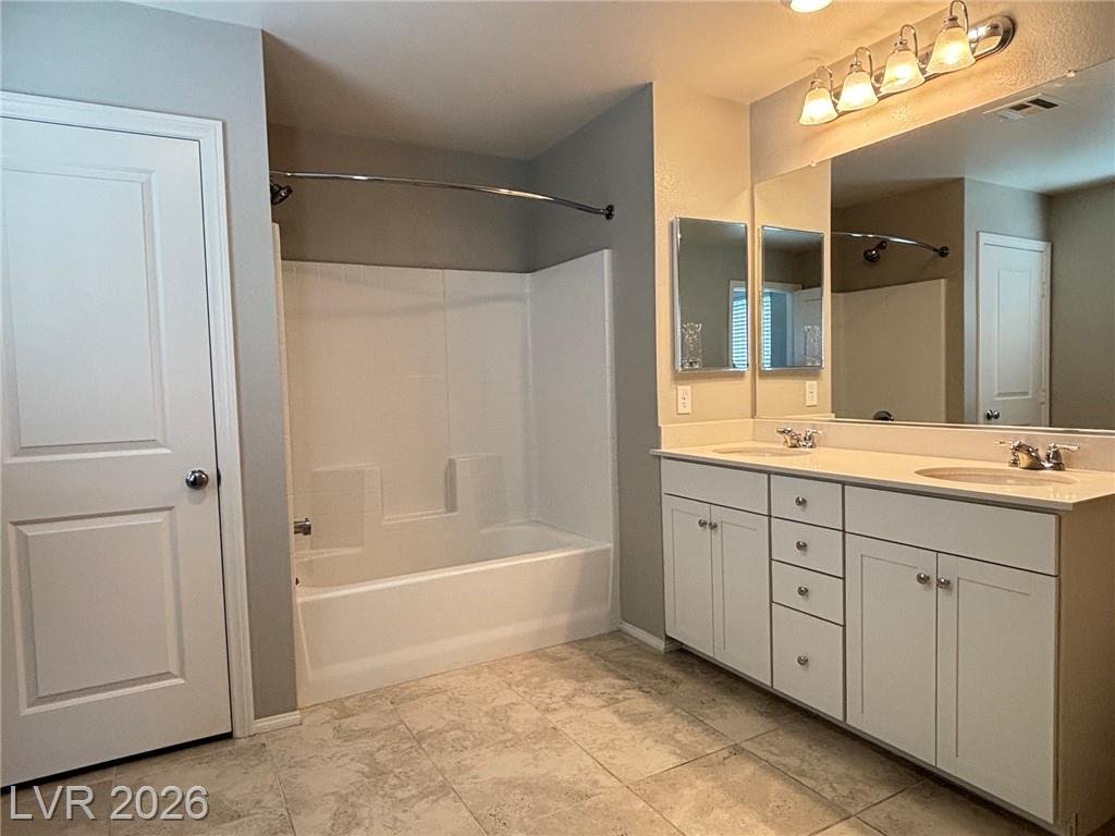 Primary bathroom tub and shower at 2850 Alenga Street beside the dual vanity