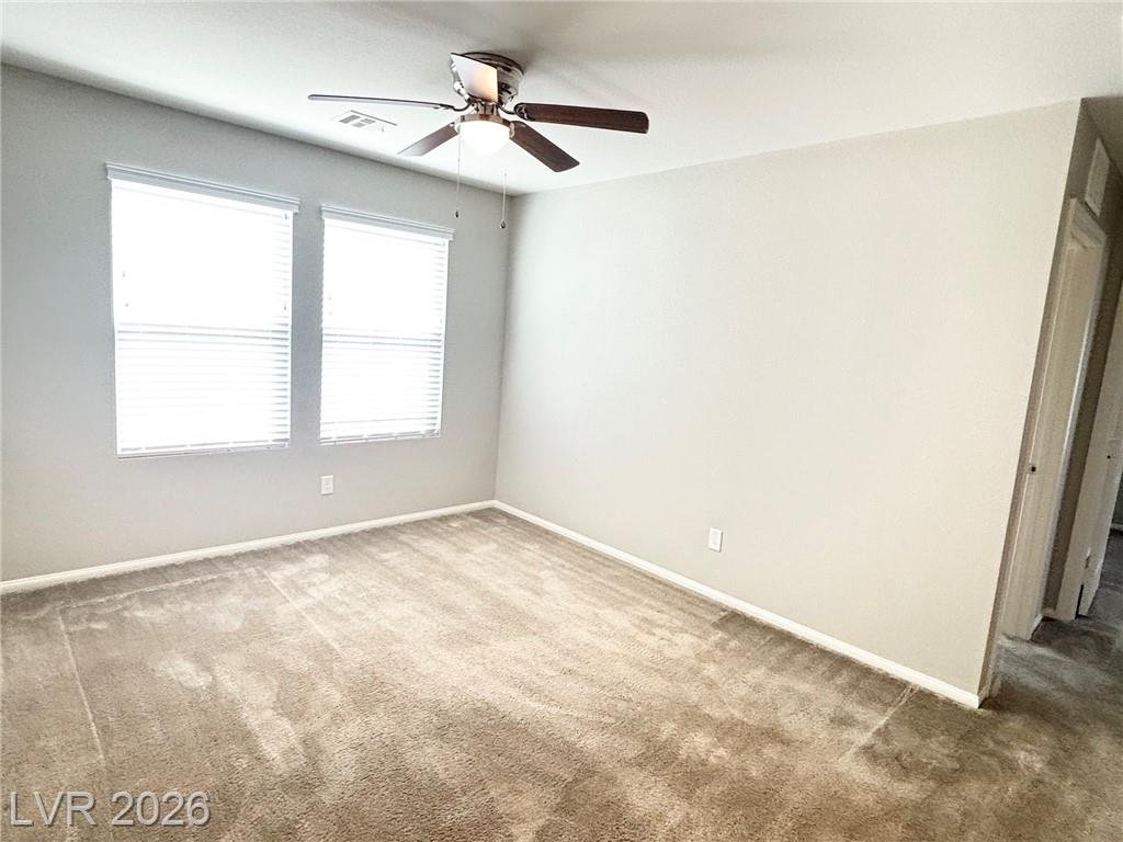 Upstairs loft at 2850 Alenga Street with a ceiling fan and dual windows