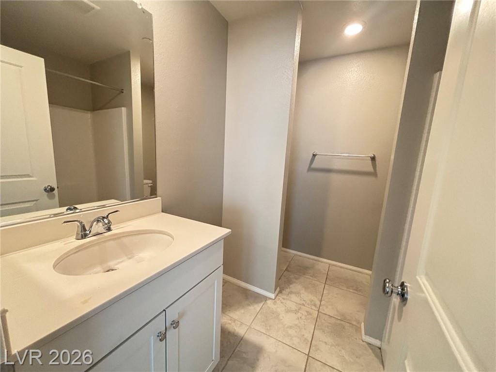 Secondary bathroom vanity with an adjoining linen closet