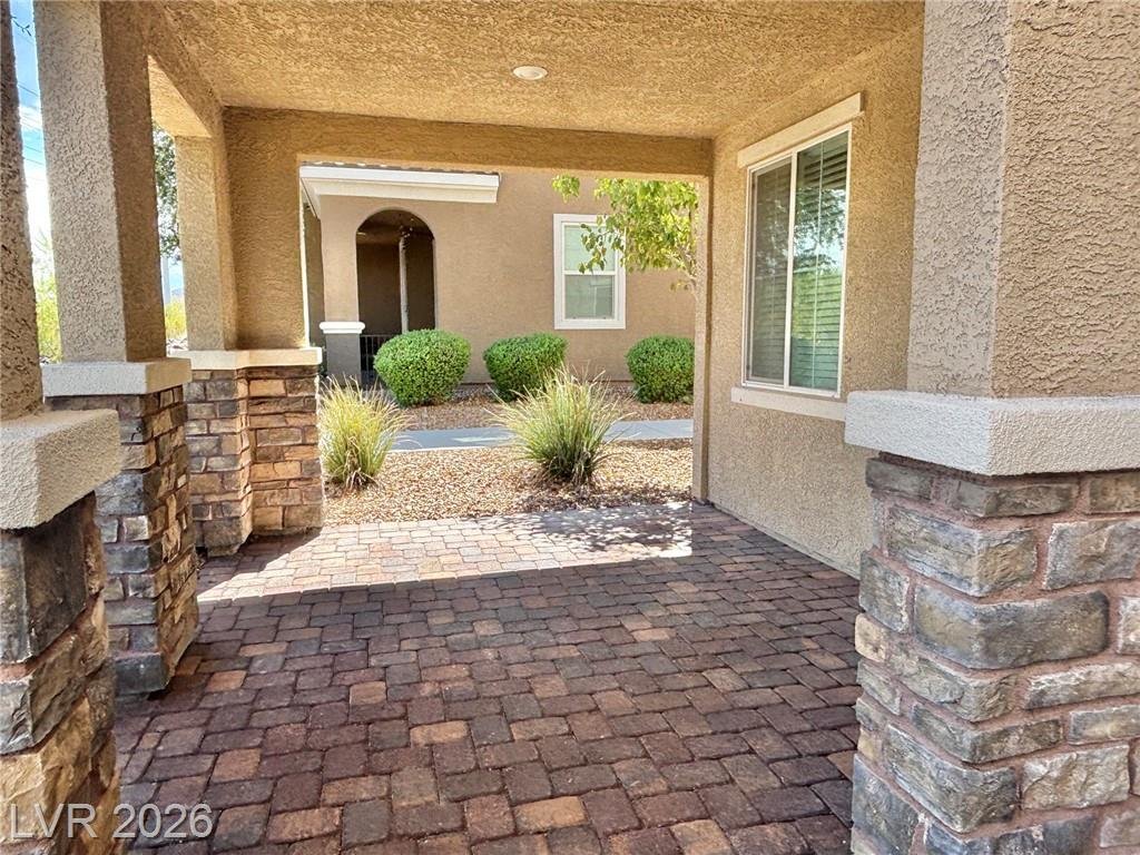 Paved side yard and covered entry with stone column accents