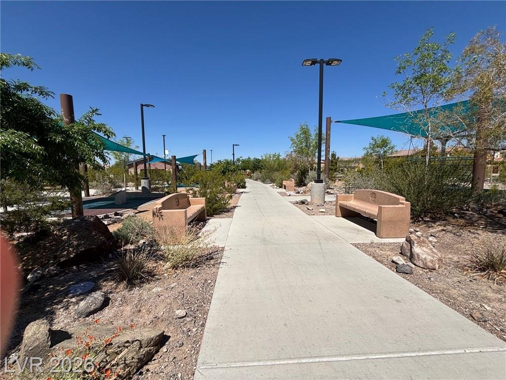 Shaded walking trail with sail canopies through the community