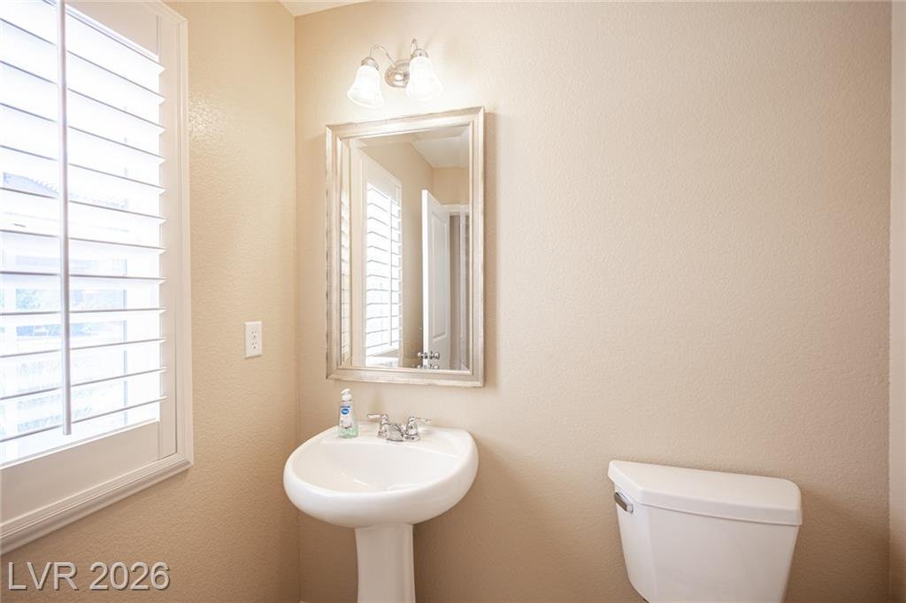 Downstairs half bath with a pedestal sink