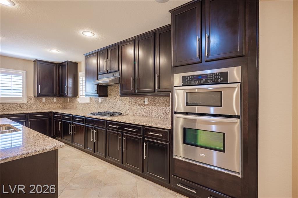 Espresso cabinets with stainless double wall ovens